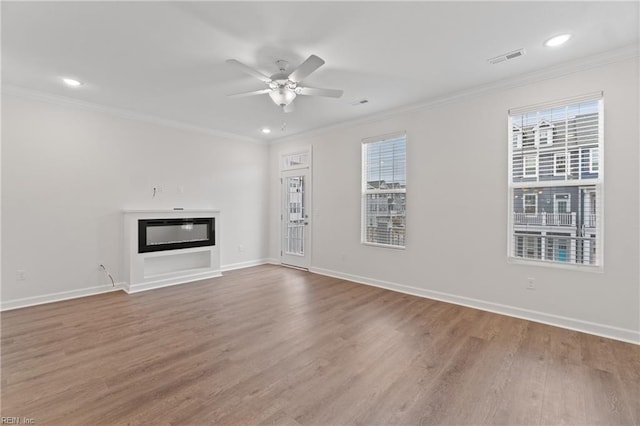 unfurnished living room with crown molding, ceiling fan, and hardwood / wood-style flooring