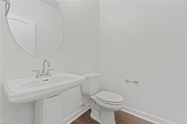 bathroom featuring hardwood / wood-style flooring and toilet