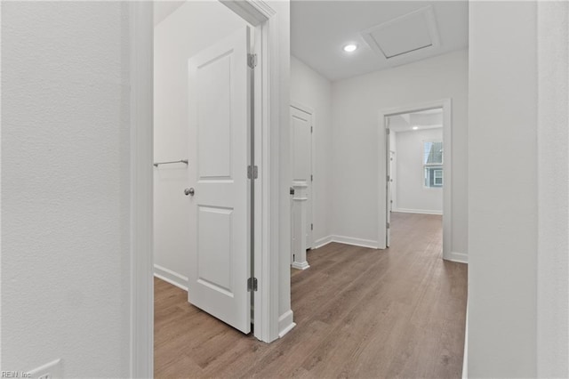 corridor with light hardwood / wood-style flooring