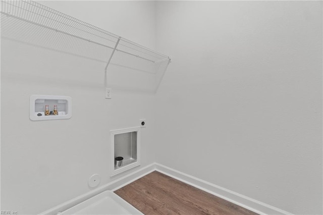 laundry area featuring hardwood / wood-style flooring, washer hookup, hookup for a gas dryer, and electric dryer hookup