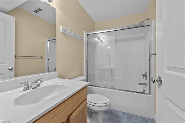 full bathroom featuring bath / shower combo with glass door, tile patterned floors, vanity, and toilet