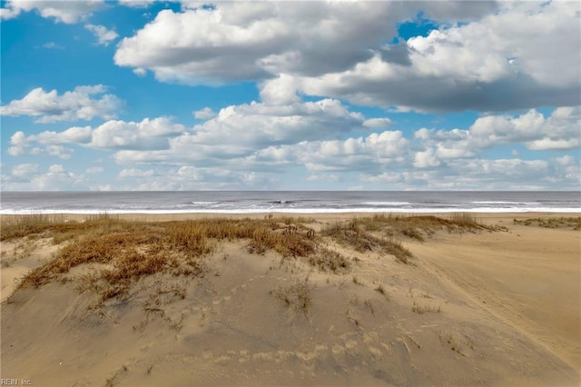 exterior space featuring a beach view and a water view