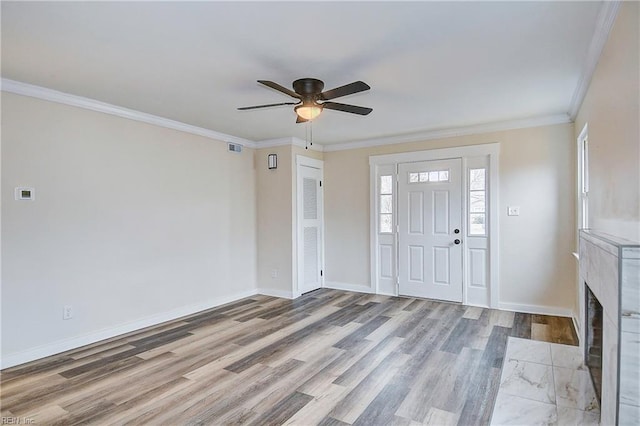 entrance foyer with ceiling fan, ornamental molding, and light hardwood / wood-style floors