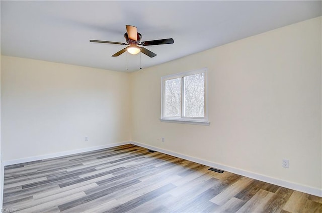 empty room featuring ceiling fan and light wood-type flooring