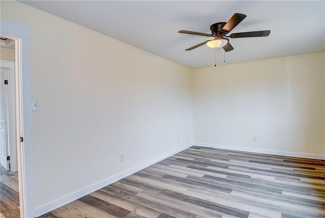 empty room with ceiling fan and light wood-type flooring