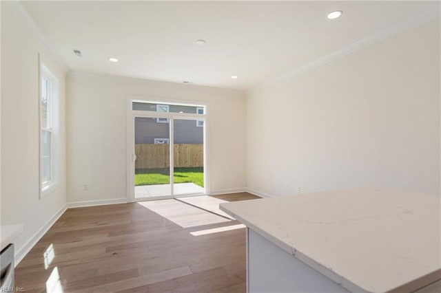 interior space with crown molding and wood-type flooring