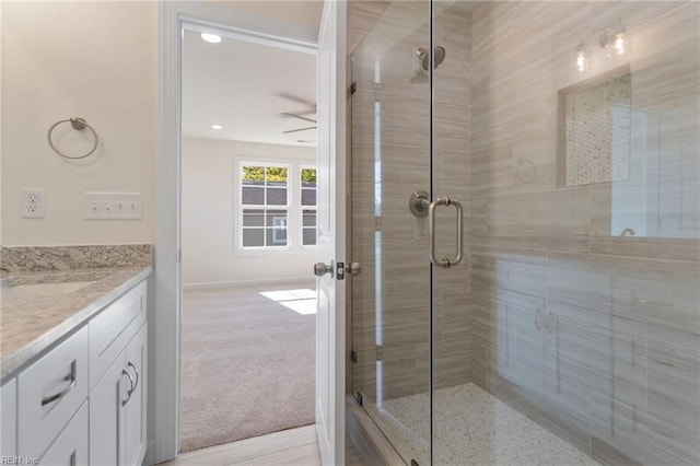 bathroom with vanity and a shower with shower door