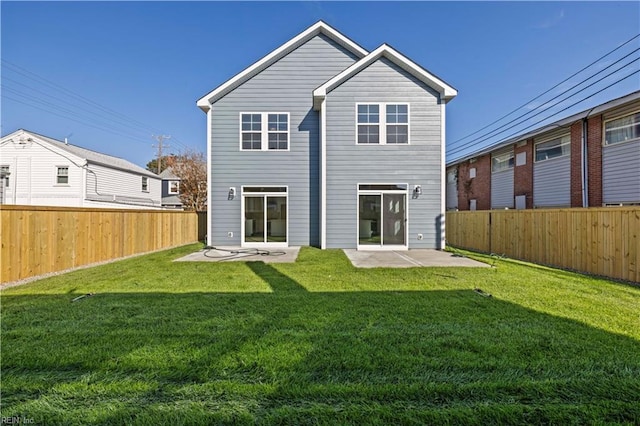 back of property featuring a yard and a patio area