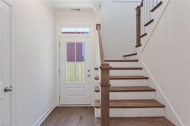 foyer entrance featuring wood-type flooring and ornamental molding