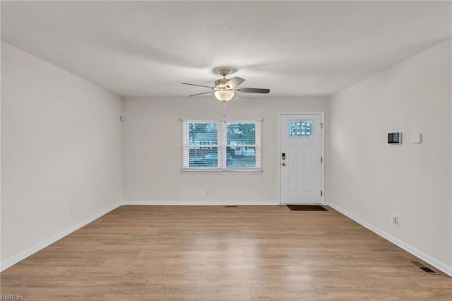 entrance foyer with ceiling fan and light wood-type flooring