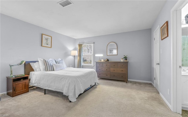 carpeted bedroom featuring ensuite bathroom