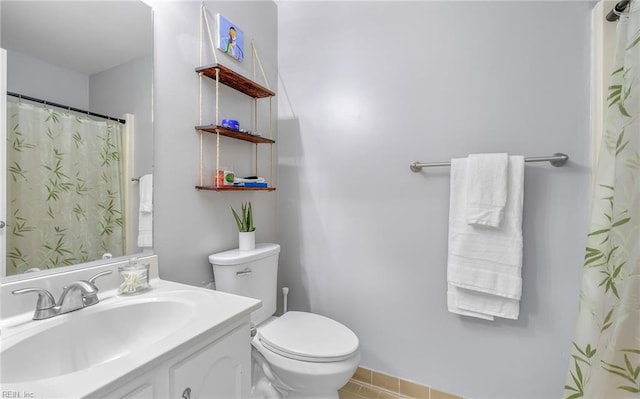 bathroom with vanity, curtained shower, and toilet