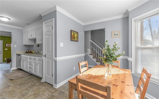 dining area featuring crown molding