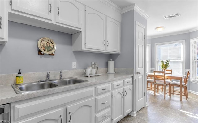 kitchen featuring crown molding, sink, and white cabinets