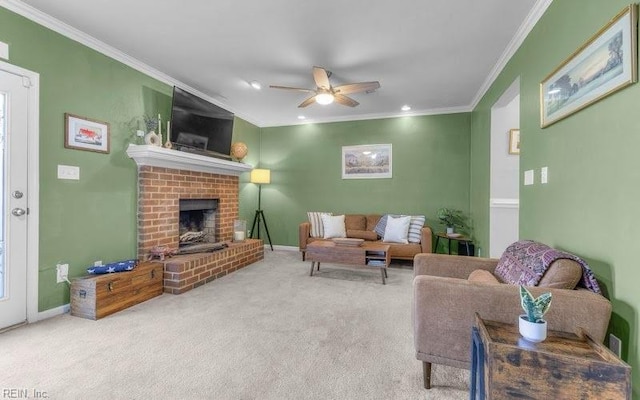 living room with crown molding, a brick fireplace, carpet flooring, and ceiling fan