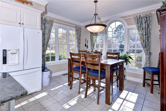 dining room with ornamental molding, plenty of natural light, and light tile patterned floors