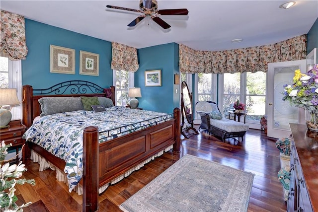 bedroom featuring dark wood-type flooring, ceiling fan, and access to exterior