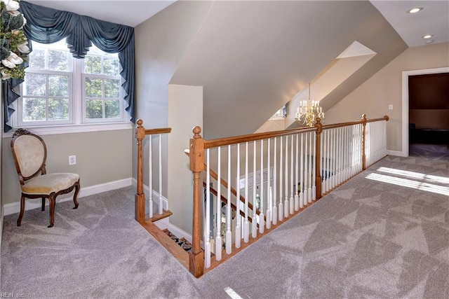 interior space featuring vaulted ceiling, a chandelier, and carpet