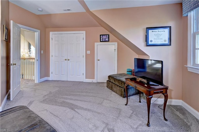 carpeted office with lofted ceiling