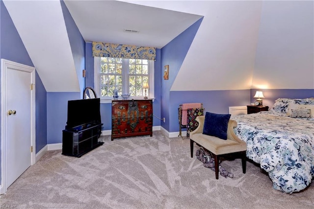 carpeted bedroom with vaulted ceiling