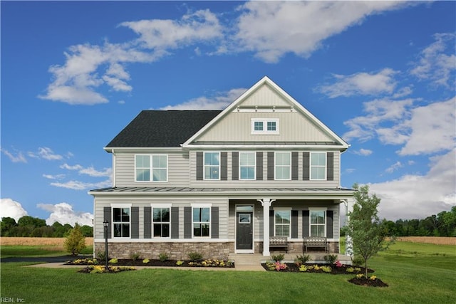 craftsman inspired home featuring a porch and a front lawn