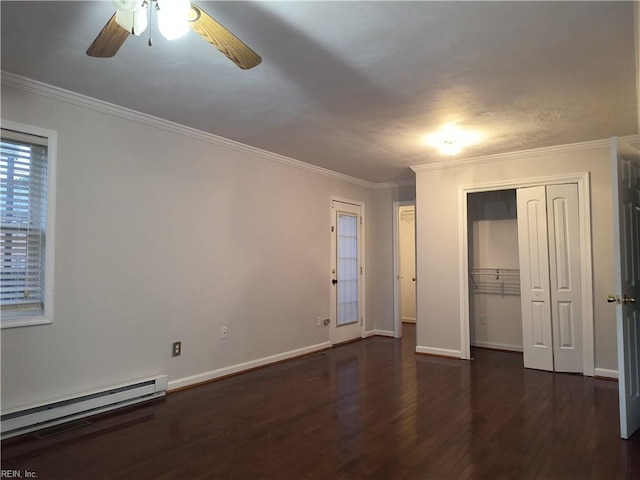 unfurnished bedroom with dark hardwood / wood-style flooring, ornamental molding, a baseboard heating unit, ceiling fan, and a closet