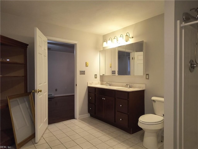 bathroom featuring vanity, toilet, tile patterned flooring, and a baseboard heating unit