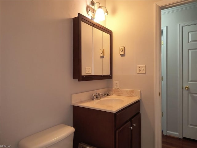 bathroom featuring vanity and toilet