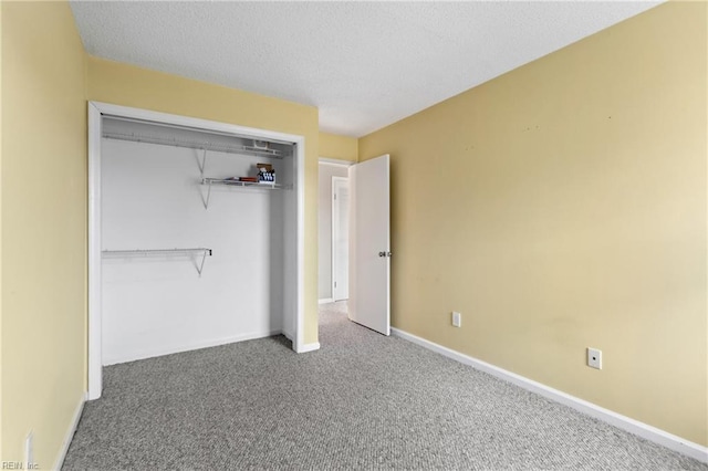 unfurnished bedroom with carpet floors, a closet, and a textured ceiling