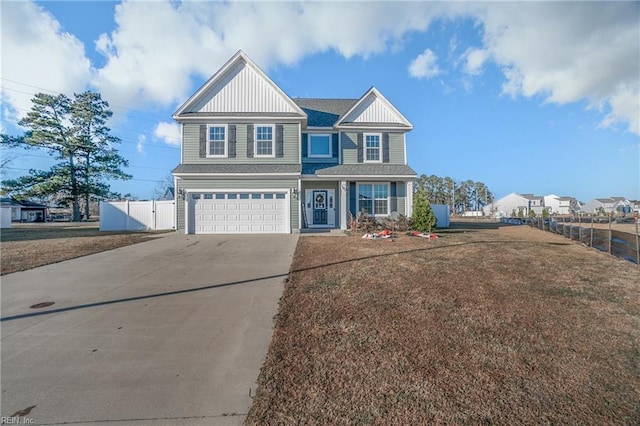 view of front of property featuring a garage and a front lawn