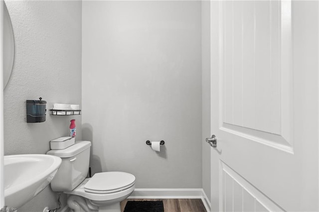 bathroom featuring toilet and hardwood / wood-style floors