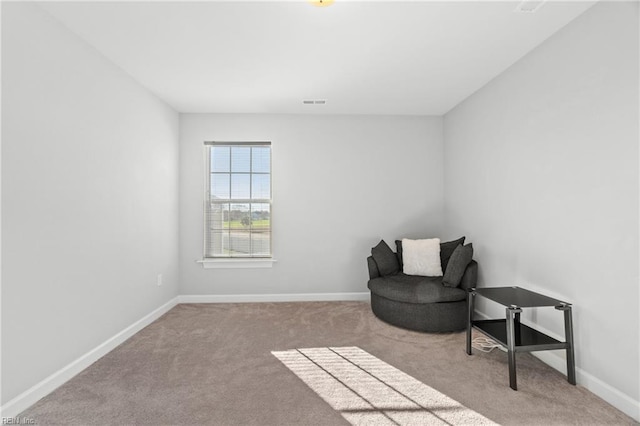 living area with light colored carpet