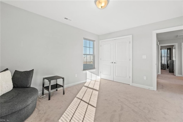 living area with light colored carpet