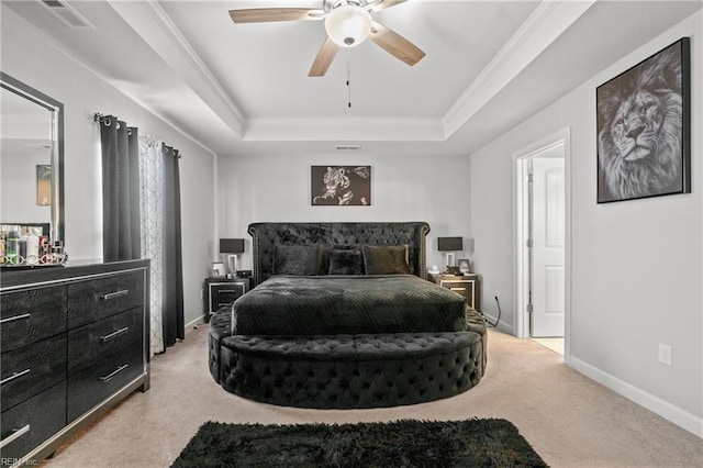 carpeted bedroom featuring ornamental molding, a raised ceiling, and ceiling fan