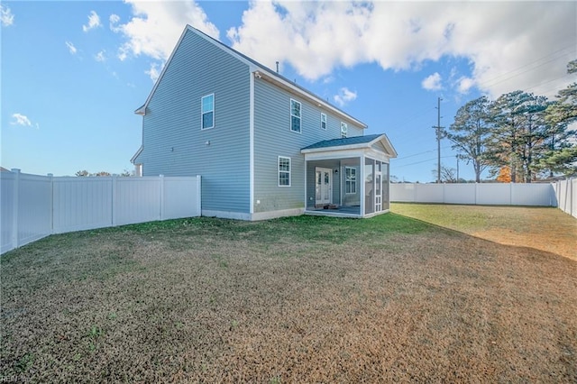 rear view of house featuring a patio area and a lawn