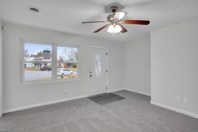 carpeted foyer entrance with ceiling fan