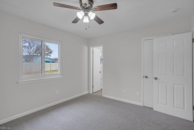 unfurnished bedroom with ceiling fan and light colored carpet