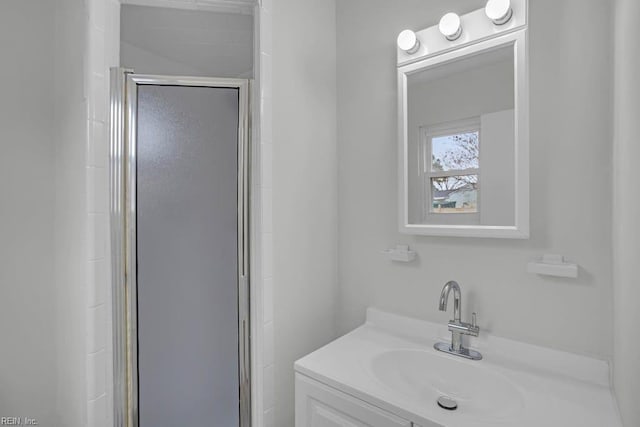 bathroom featuring vanity and a shower with door