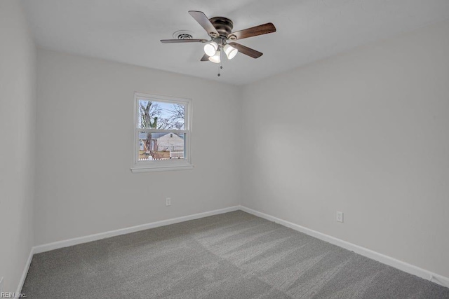 carpeted spare room with ceiling fan