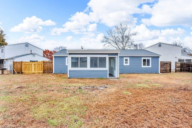 rear view of house with a yard