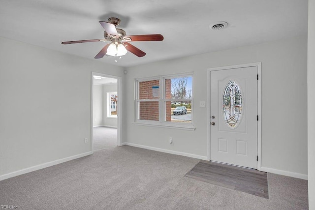 entryway featuring ceiling fan and light colored carpet