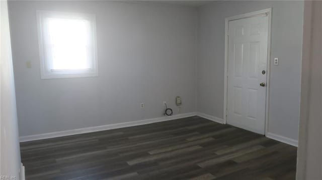 empty room with dark hardwood / wood-style flooring