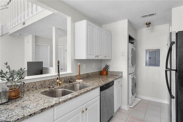 kitchen with sink, dishwasher, refrigerator, white cabinetry, and stacked washer / drying machine