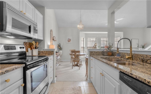 kitchen featuring stainless steel appliances, white cabinetry, and sink