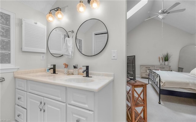 bathroom featuring ceiling fan, lofted ceiling, and vanity