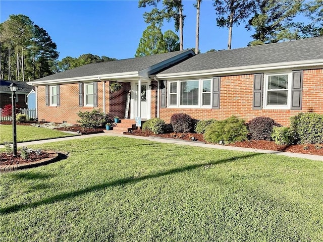 ranch-style home with a front lawn