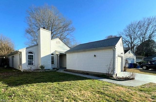 exterior space featuring a garage and a lawn