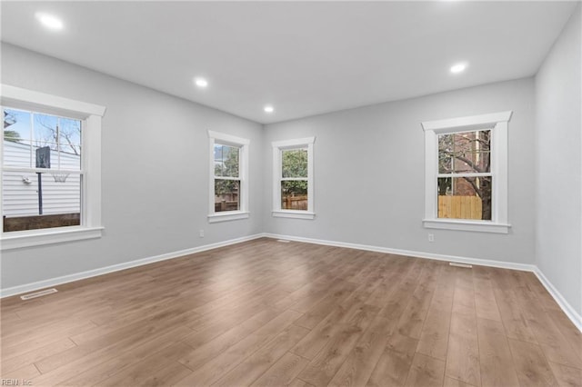 empty room with light hardwood / wood-style flooring