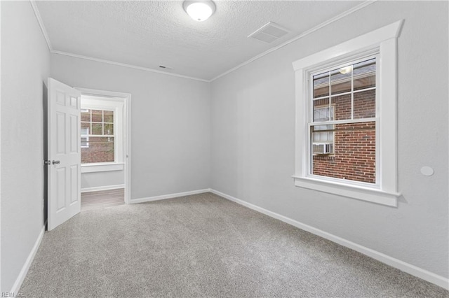 carpeted spare room featuring crown molding, cooling unit, and a textured ceiling