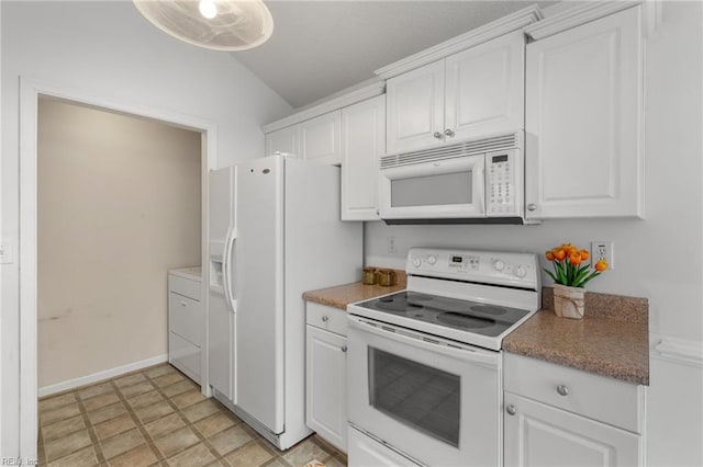 kitchen featuring white appliances, washer / clothes dryer, vaulted ceiling, and white cabinets